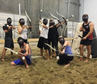 Seven canada drives employees at an archery team-building event.